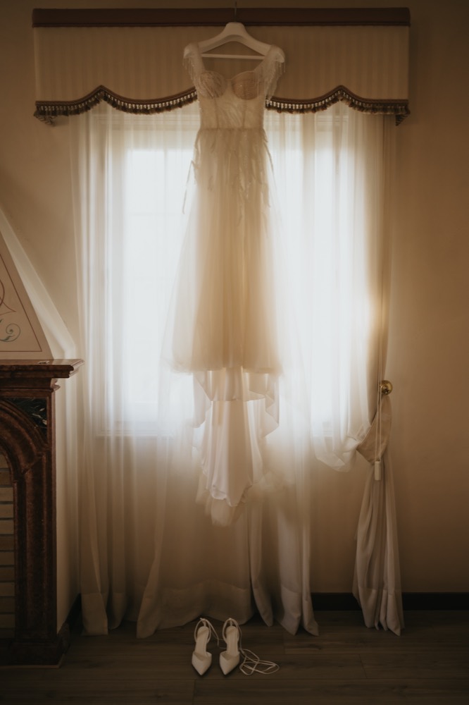 Wedding dress hanging at the window