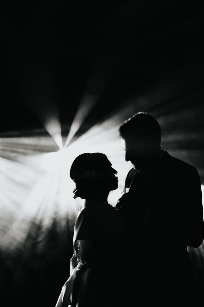 The couple dancing in silhouette