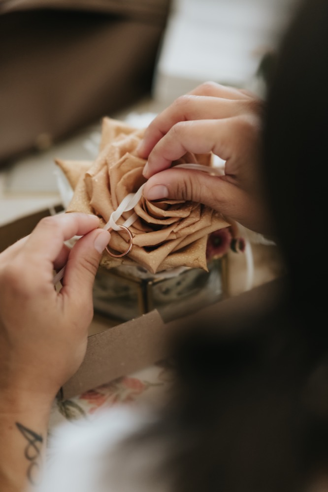 Hands arranging a floral detail