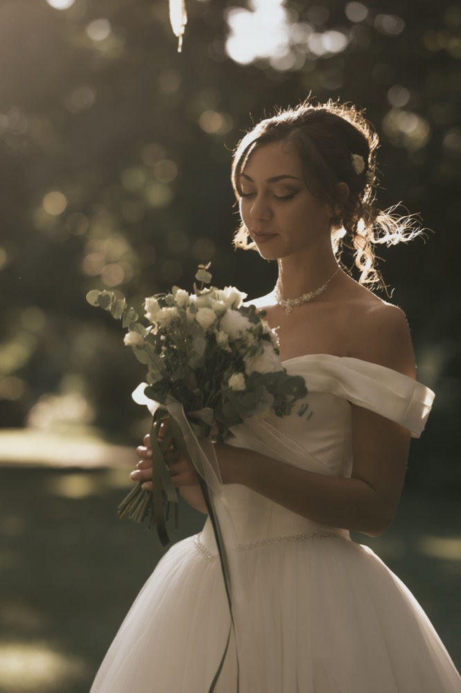 The bride with her bouquet at sunset