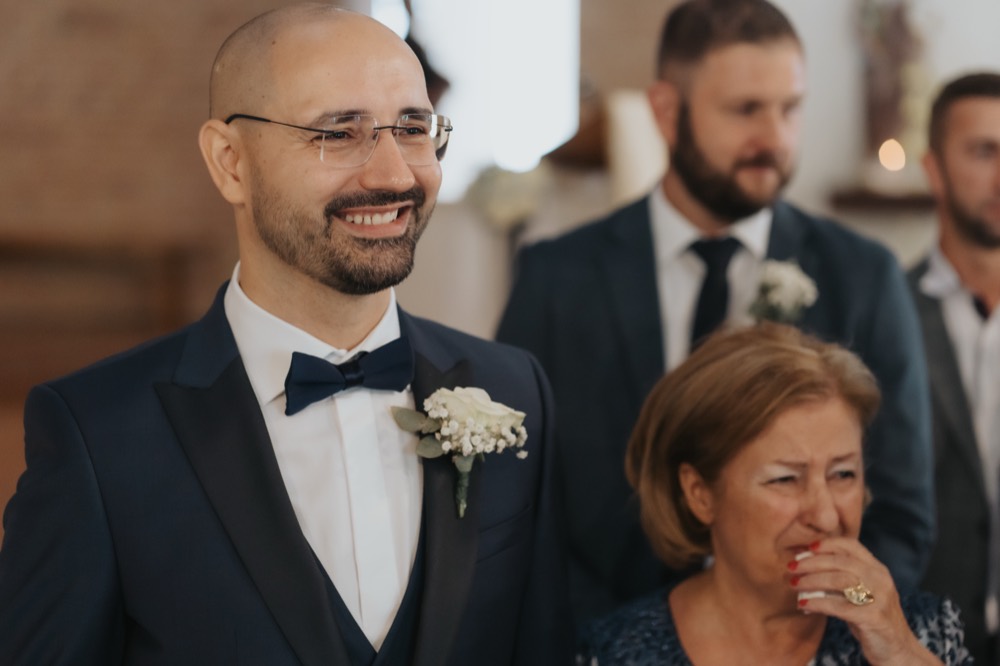 The groom moved at the altar, his mother in tears