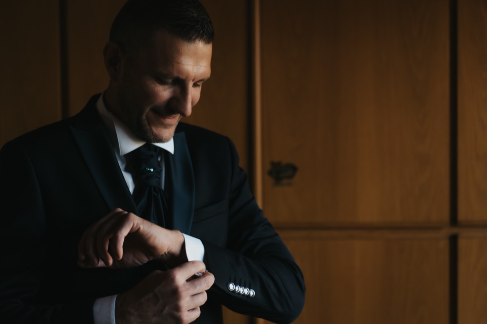 The groom fastening his cuff