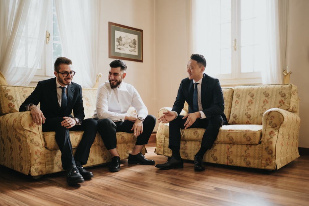 The groom with friends on the sofa