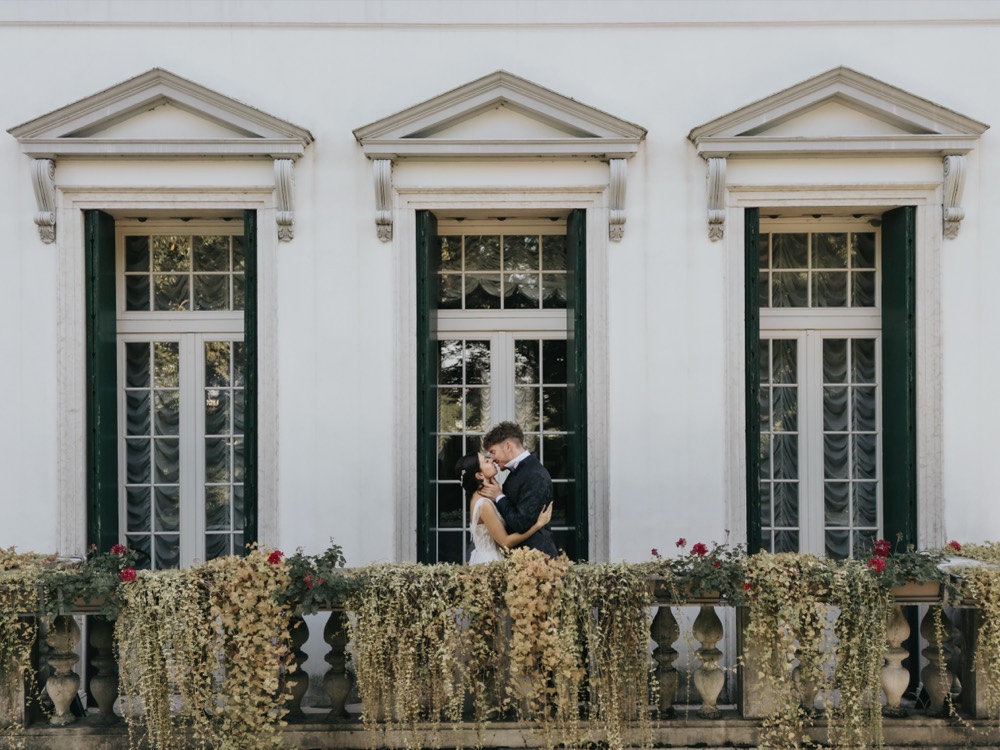 The couple on a villa balcony with flowers